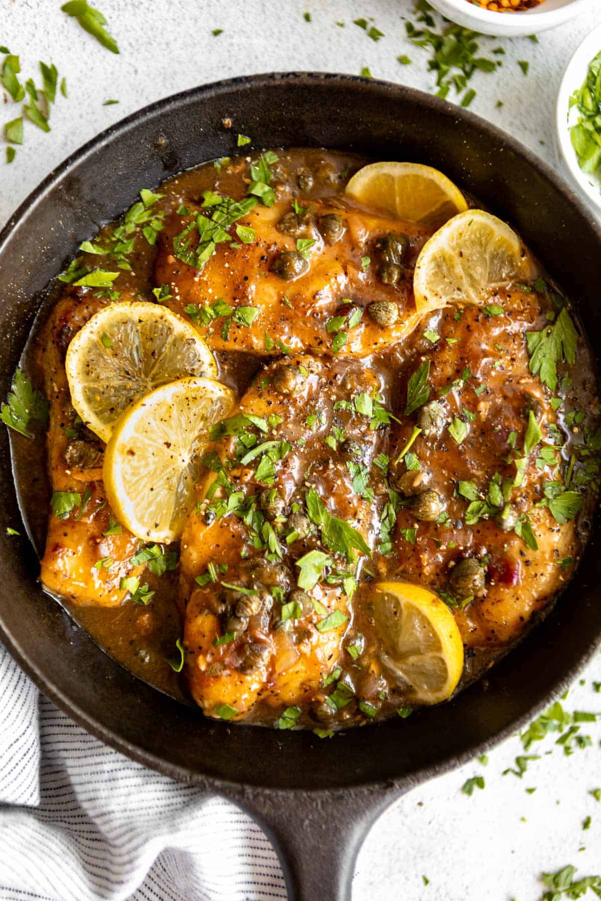 gluten free chicken piccata in a pan with lemon and capers