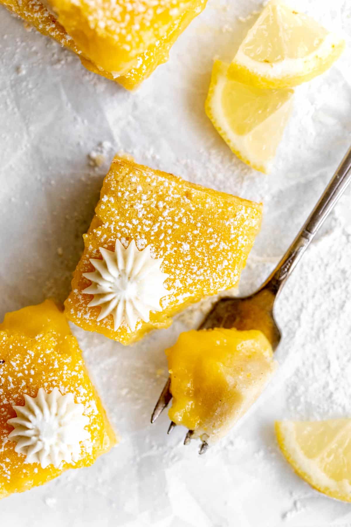 gluten free lemon bars with a fork and a bite
