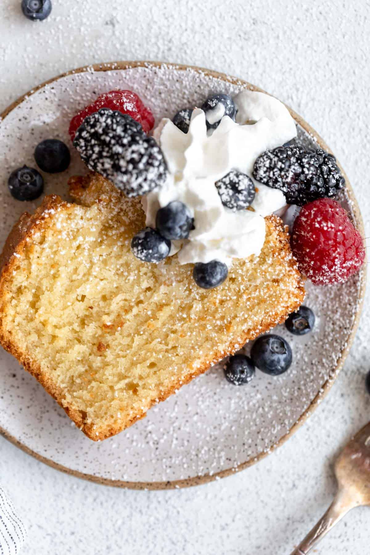 gluten free pound cake on a plate with whipped cream