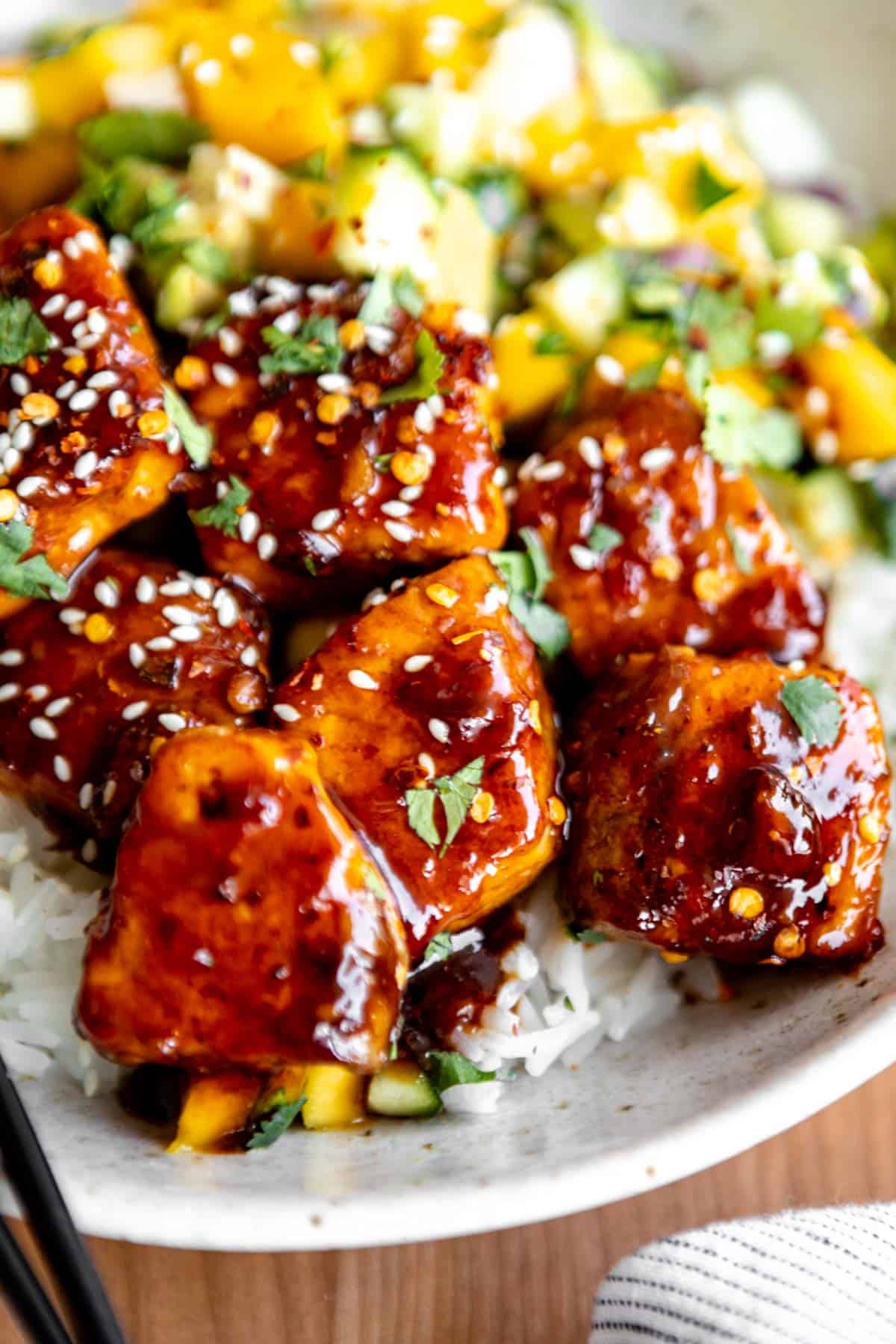 angled view of the salmon bites with rice and ginger sauce