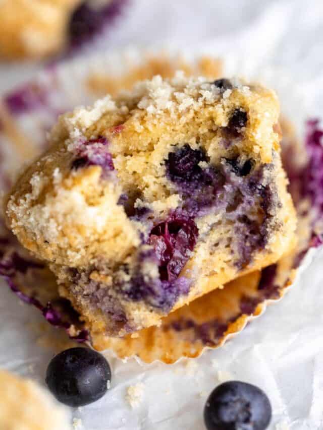 one bite taken out of the blueberry muffin