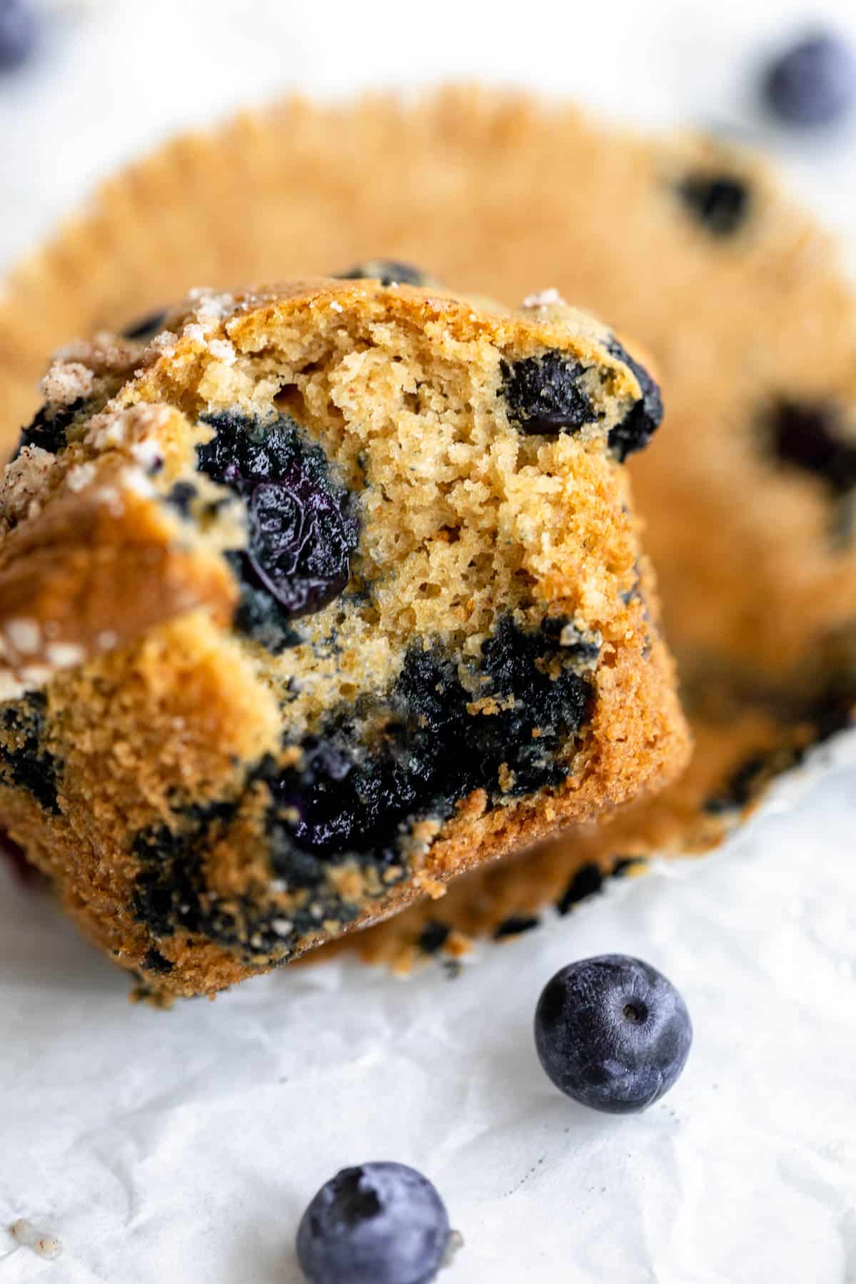 one gluten free blueberry muffin with a bite taken out