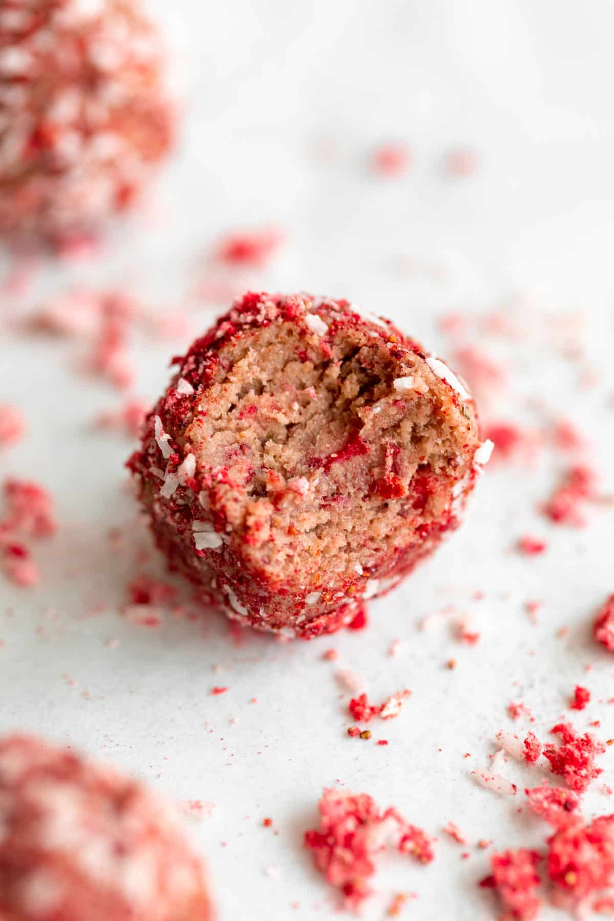 strawberry protein energy balls with a bite taken out