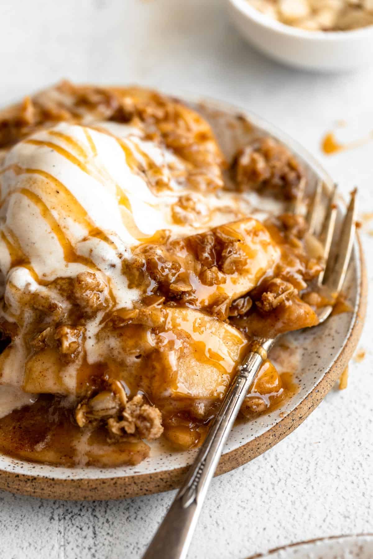 angled view of the healthy apple crisp with a fork on the side