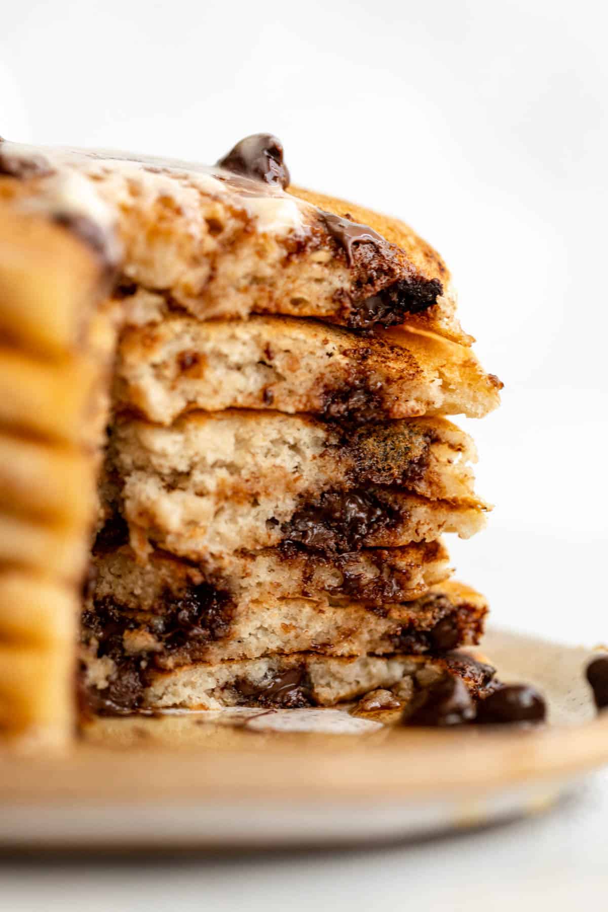 stack of gluten free pancakes with a bite cut out to show fluffy texture