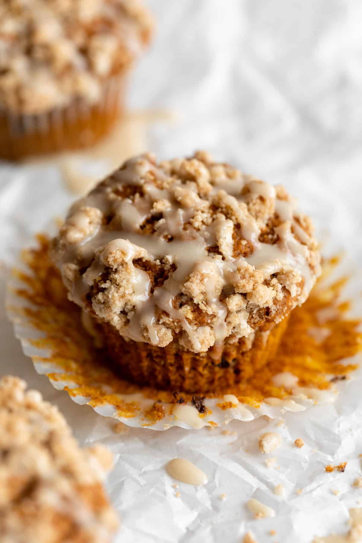 gluten free pumpkin muffins with streusel and glaze on top