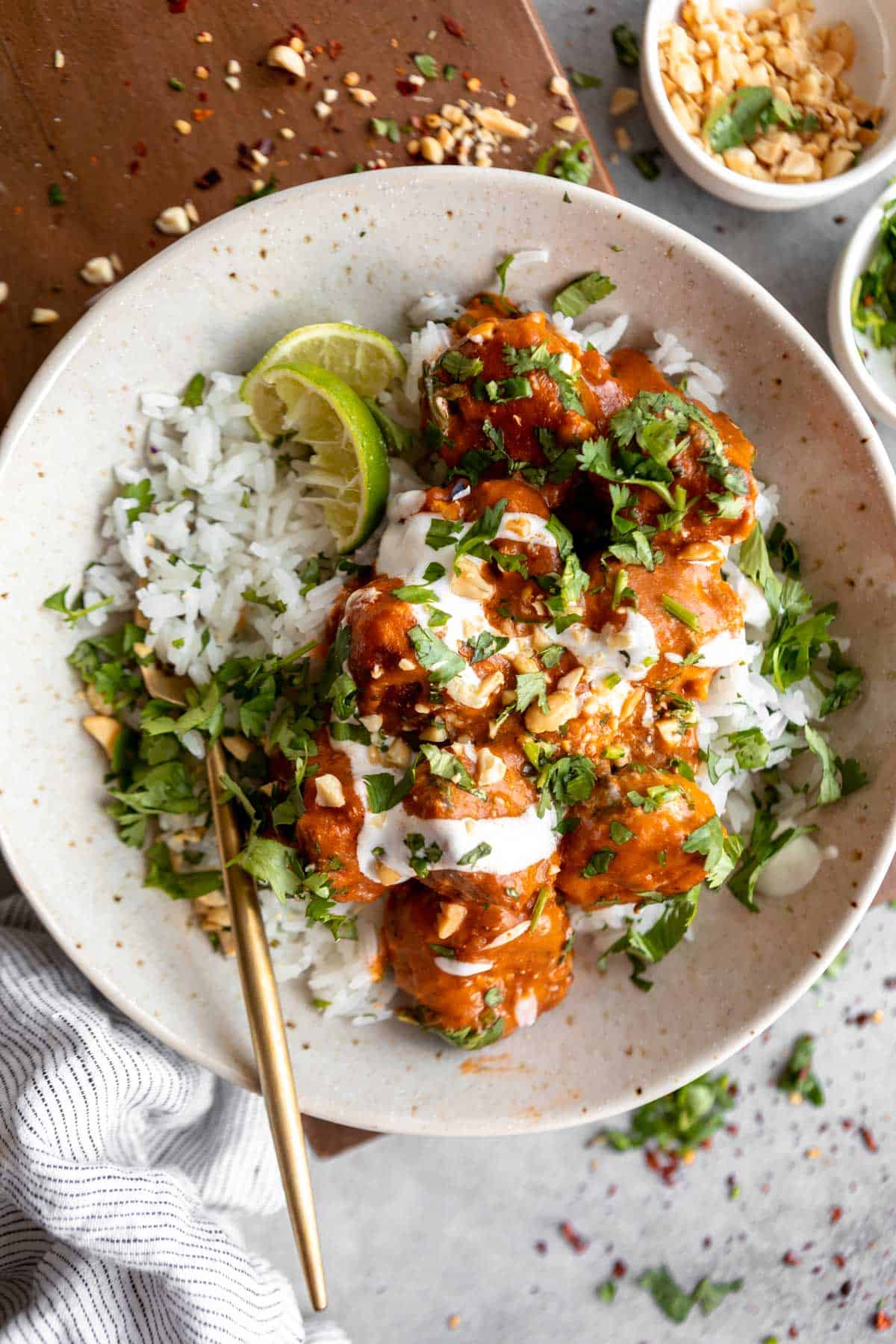 thai curry chicken meatballs in a bowl with rice and cilantro