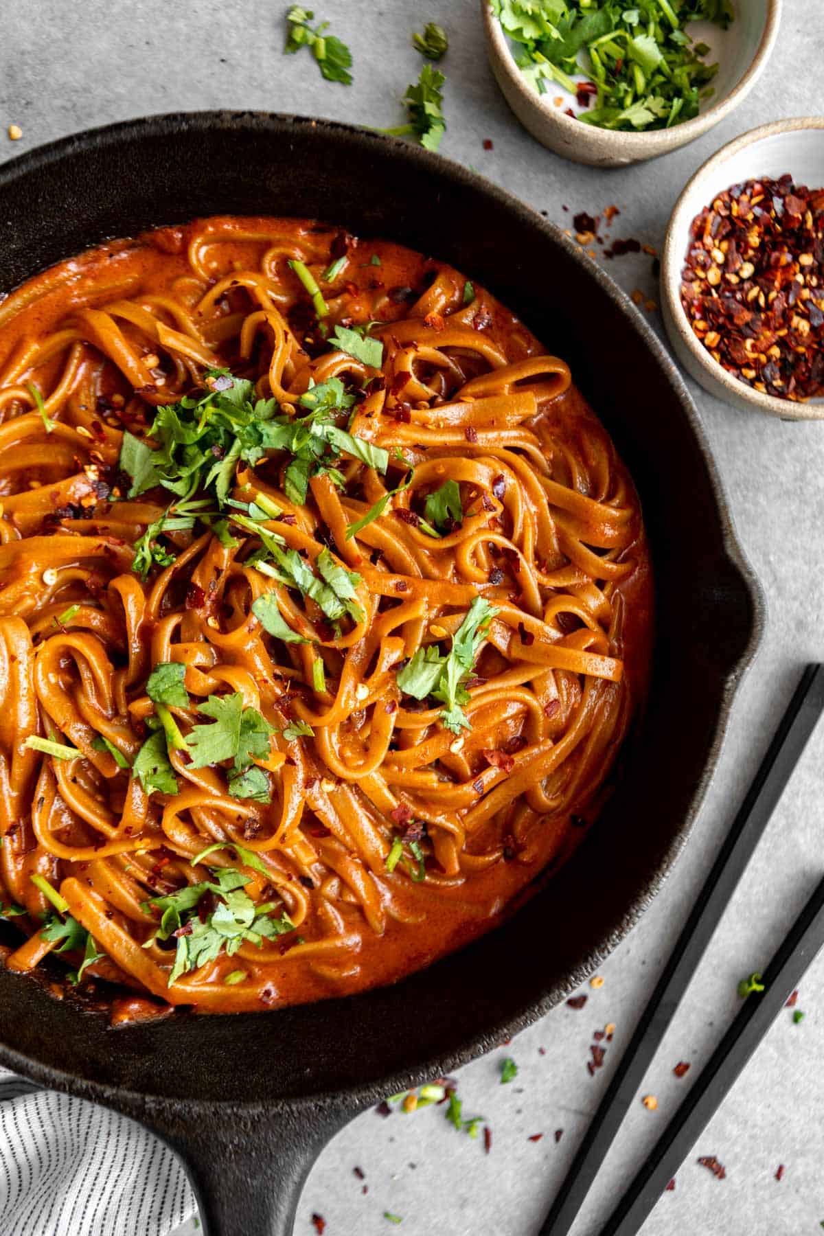 thai red curry noodles in a pot with cilantro on top