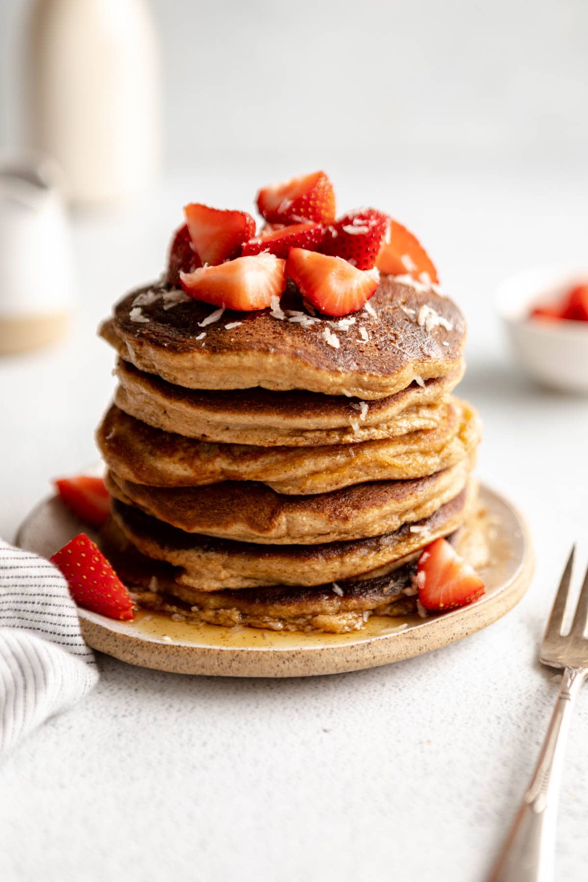 coconut flour pancakes on a plate with maple syrup