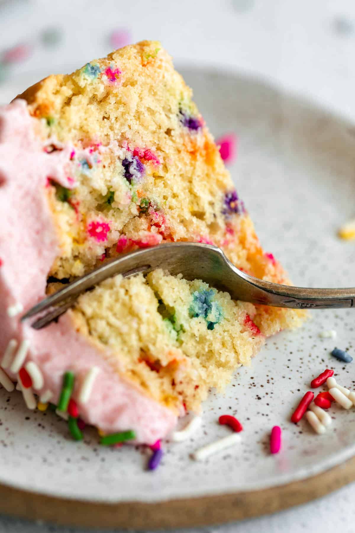 gluten free mini vanilla cake with sprinkles on a plate