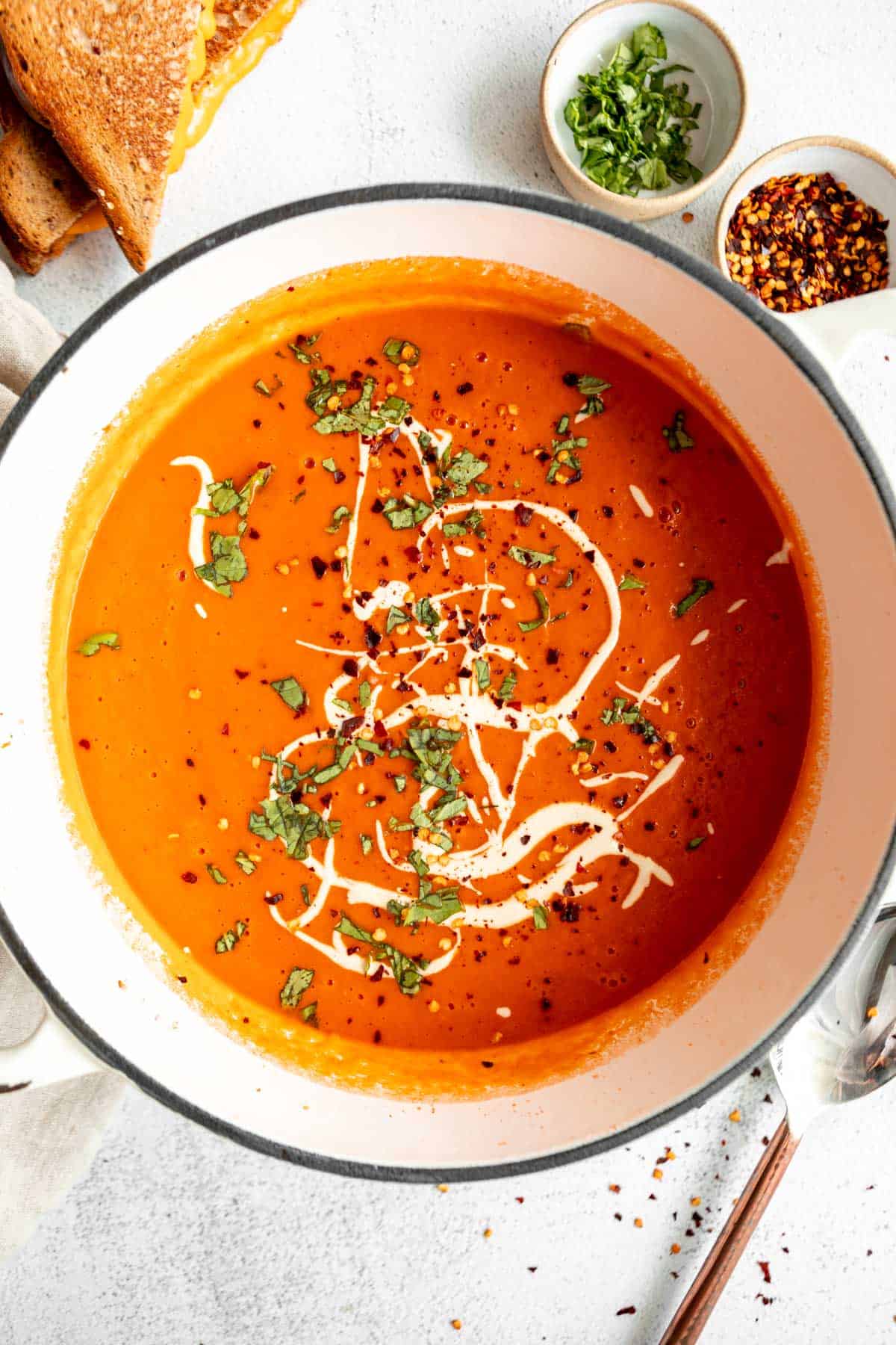 vegan tomato soup in a pot with basil