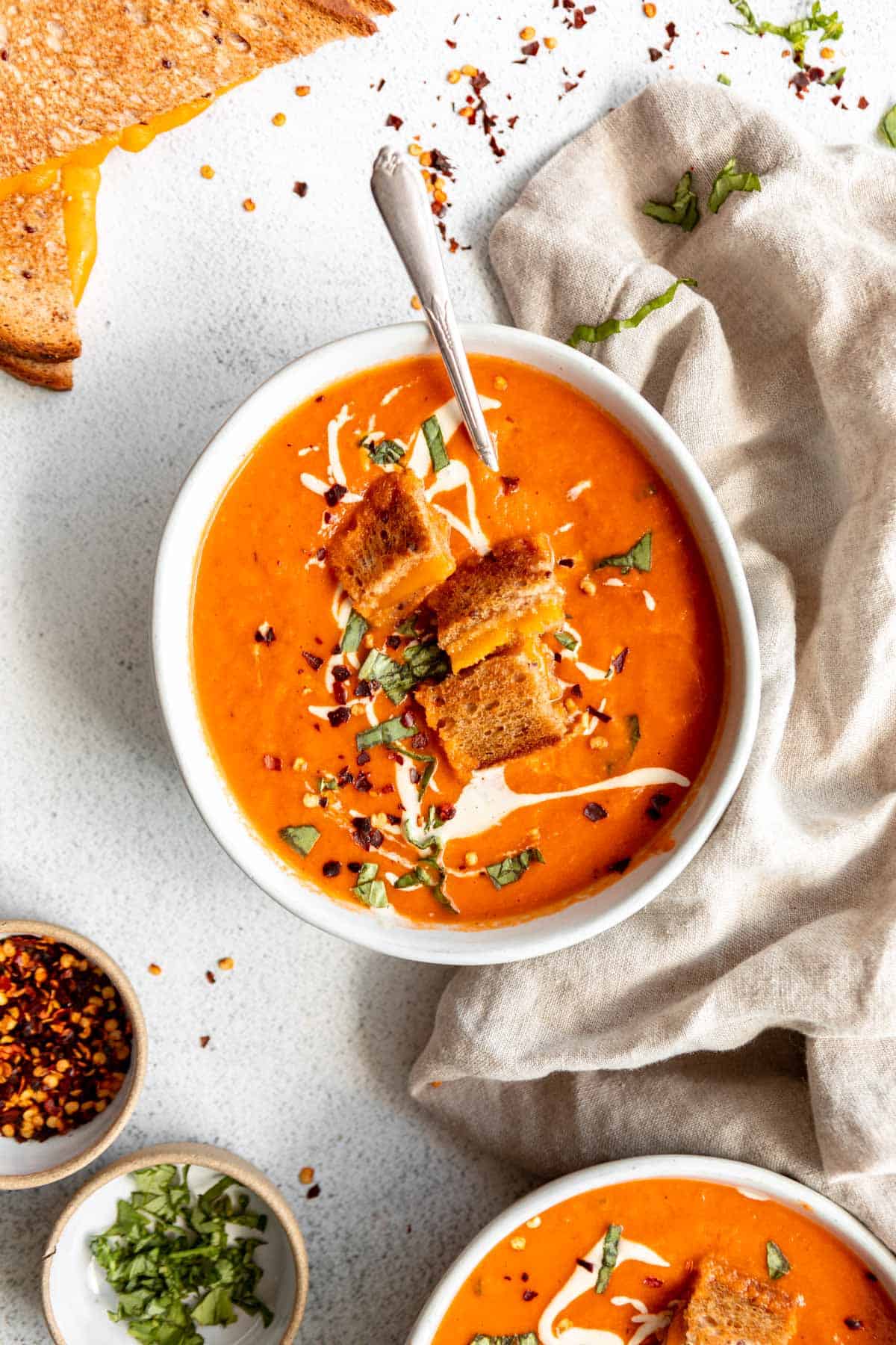 vegan tomato soup with grilled cheese on top