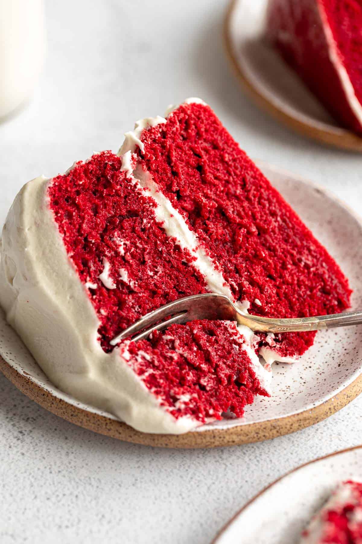 gluten free red velvet cake on a plate with a fork