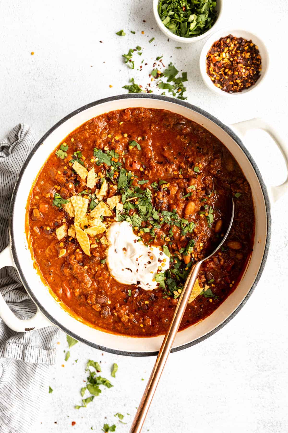 gluten free chili in a big pot with a spoon on the side