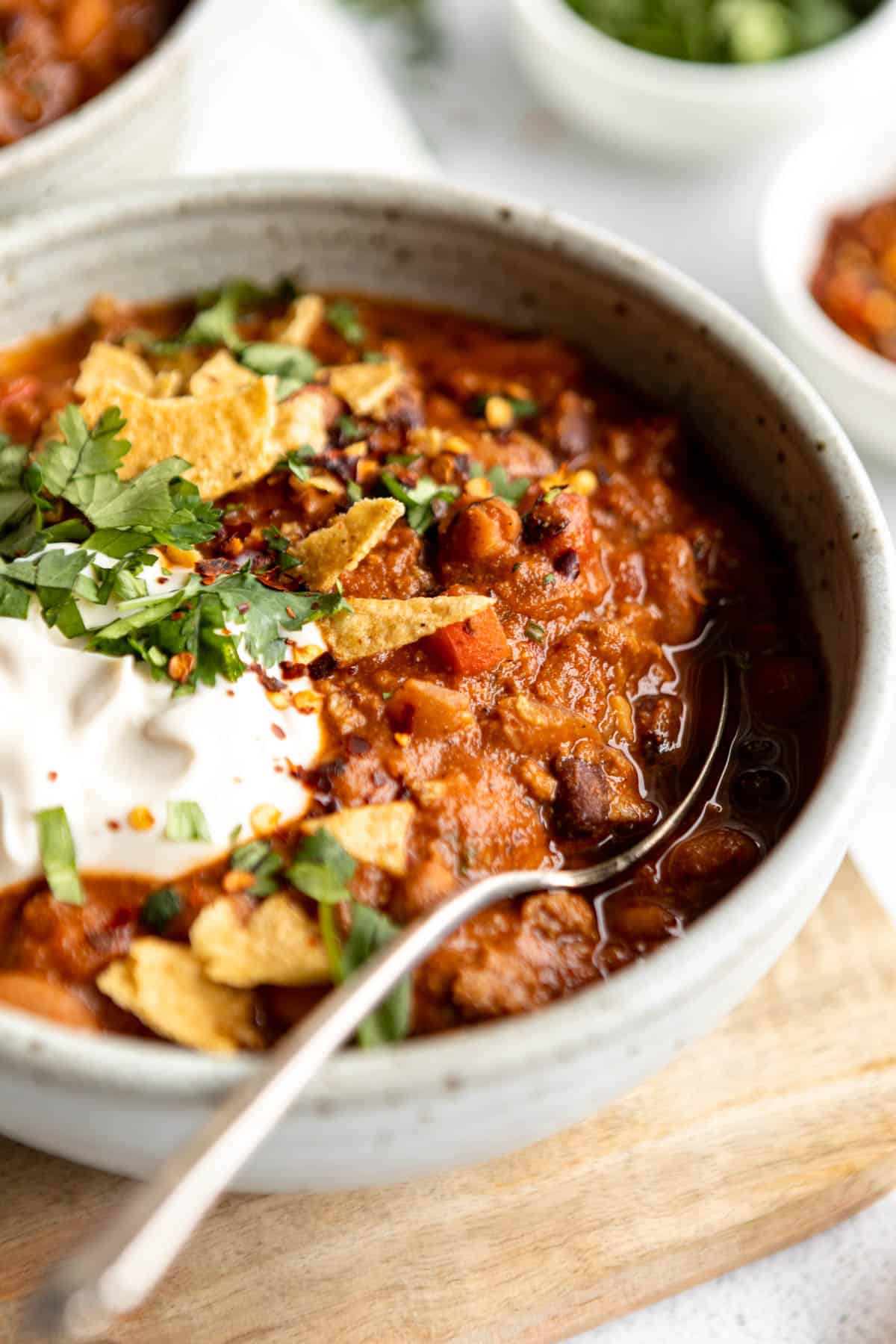 up close of the gluten free chili with cilantro and a spoon on the side