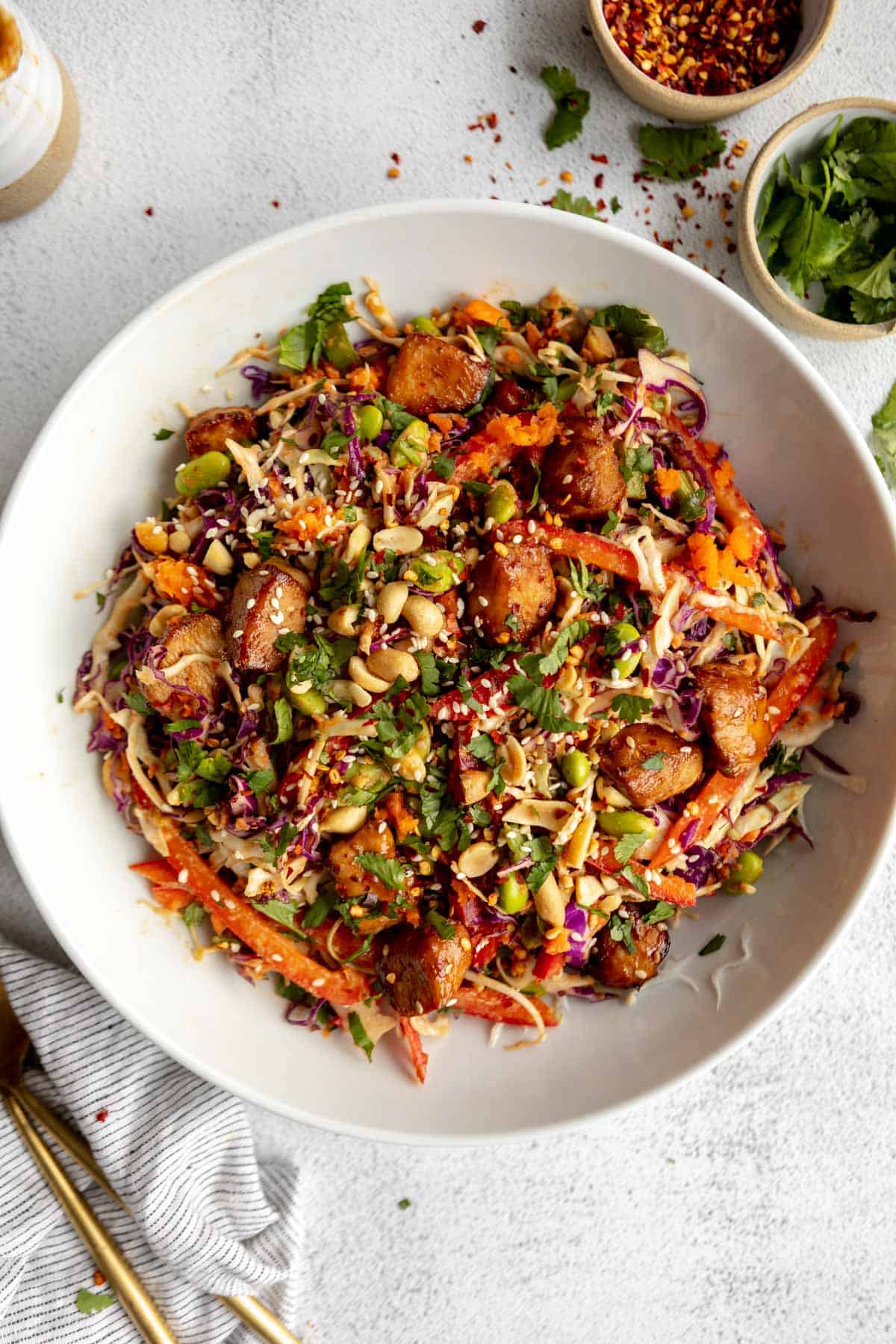 asian chicken crunch salad in a bowl with peanut dressing
