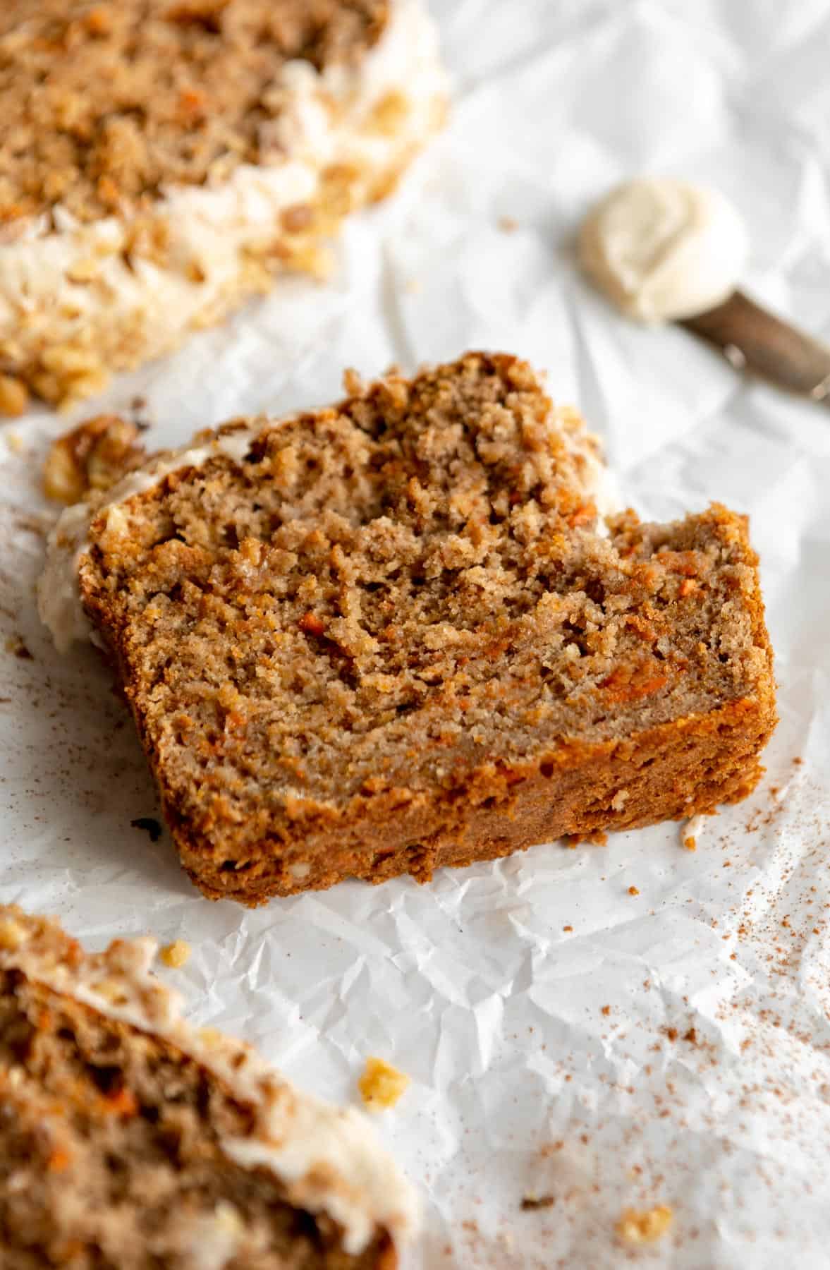 carrot cake banana bread on parchment paper with a bite taken out