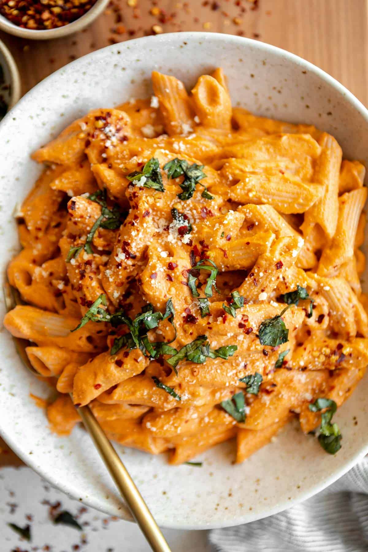creamy vegan tomato basil pasta sauce with penne in a bowl