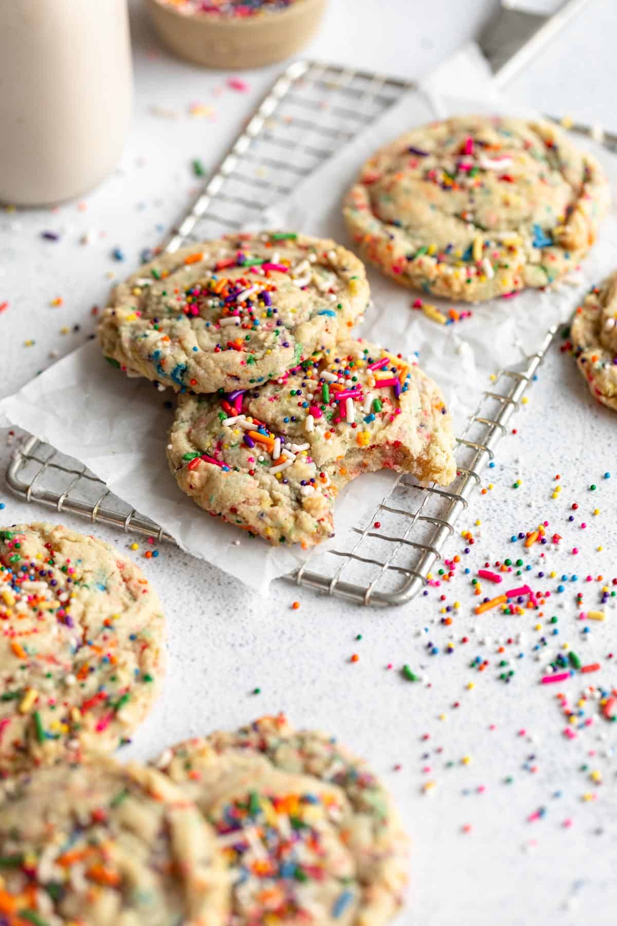 vegan sugar cookies with sprinkles and a bite taken out