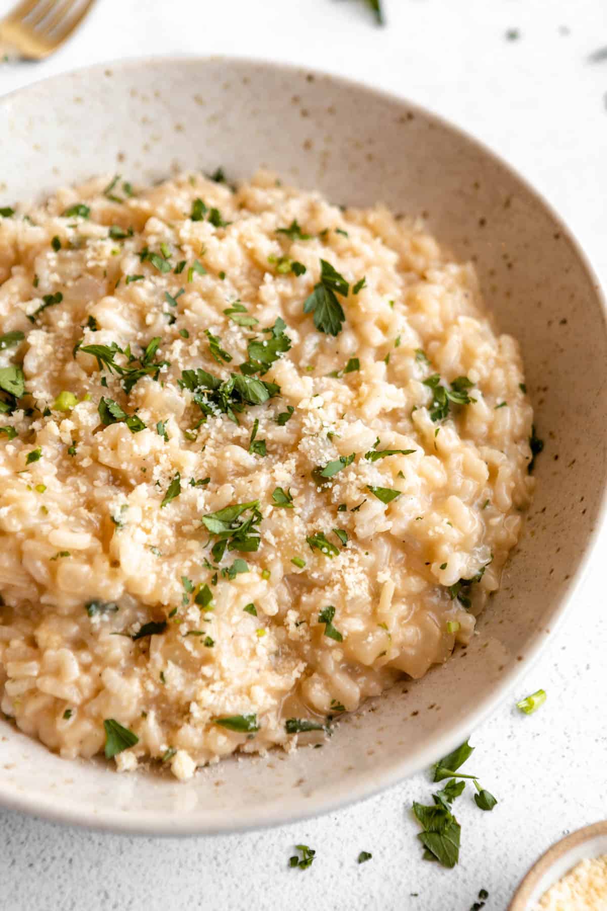 gluten free parmesan risotto in a bowl with herbs