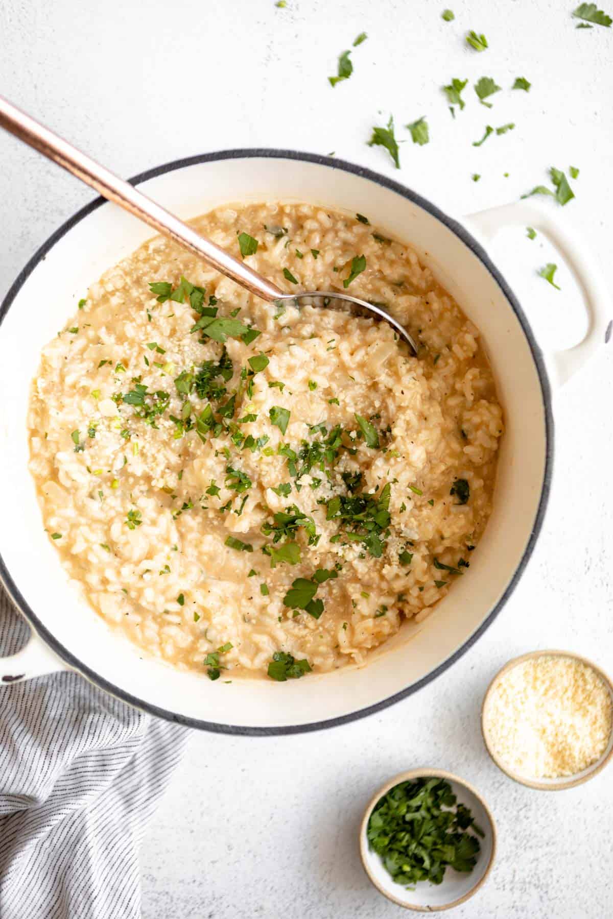 pot of gluten free risotto with fresh herbs on top