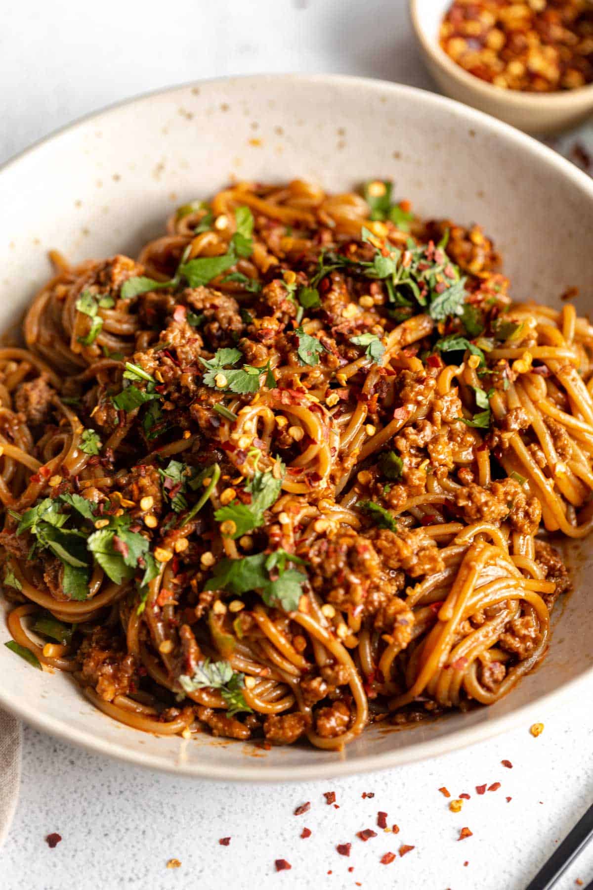korean gochujang beef noodles in a bowl with scallions