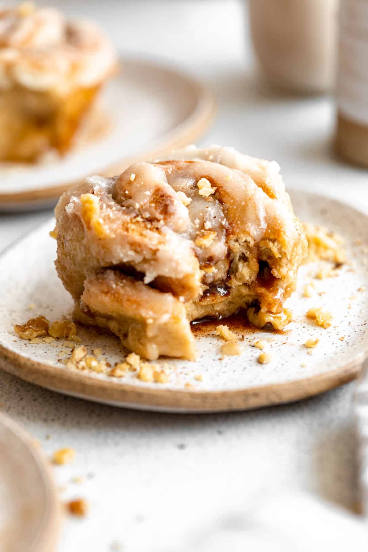 gluten free cinnamon rolls on a plate with a bite taken out