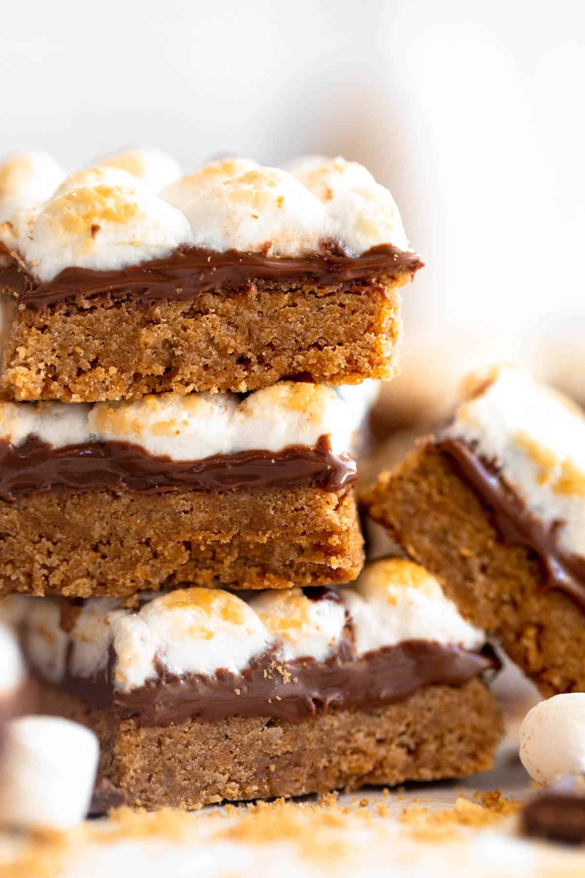 gluten free s'mores bars stacked on parchment paper