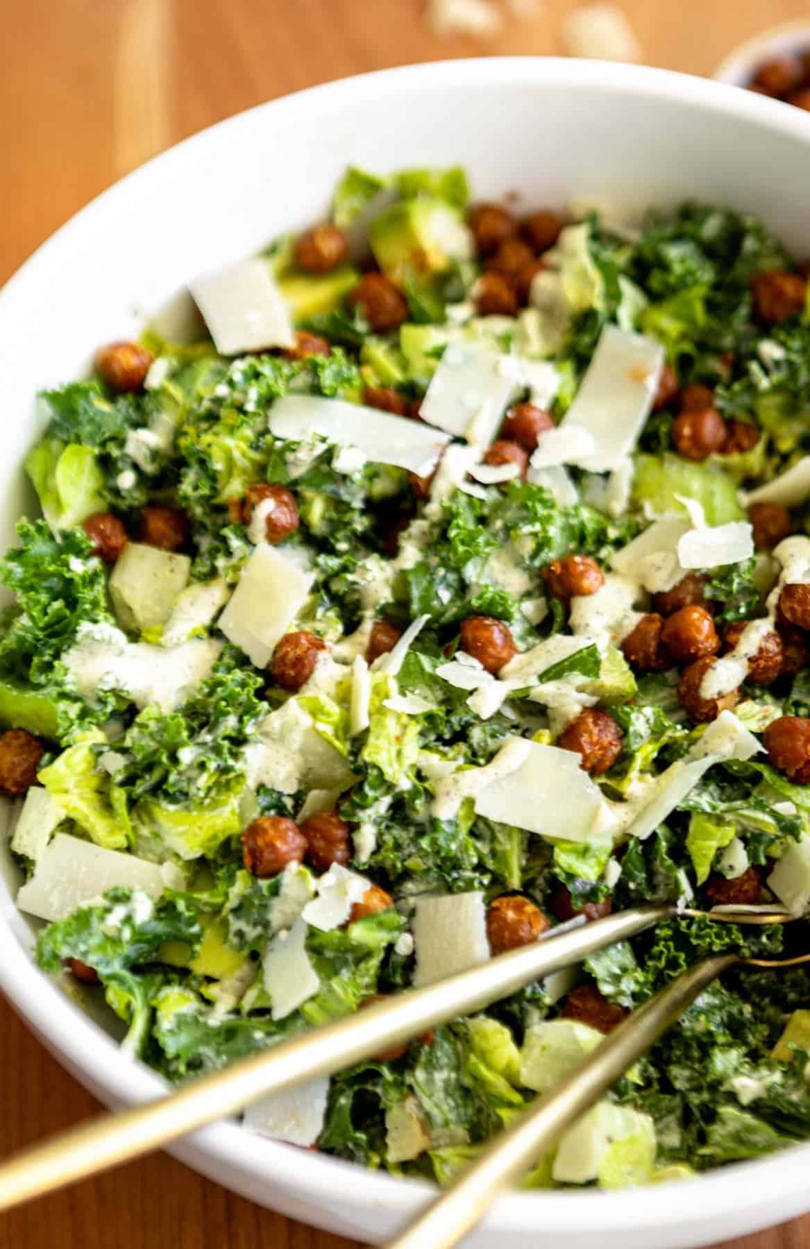 large white bowl with the kale caesar salad with vegan dressing