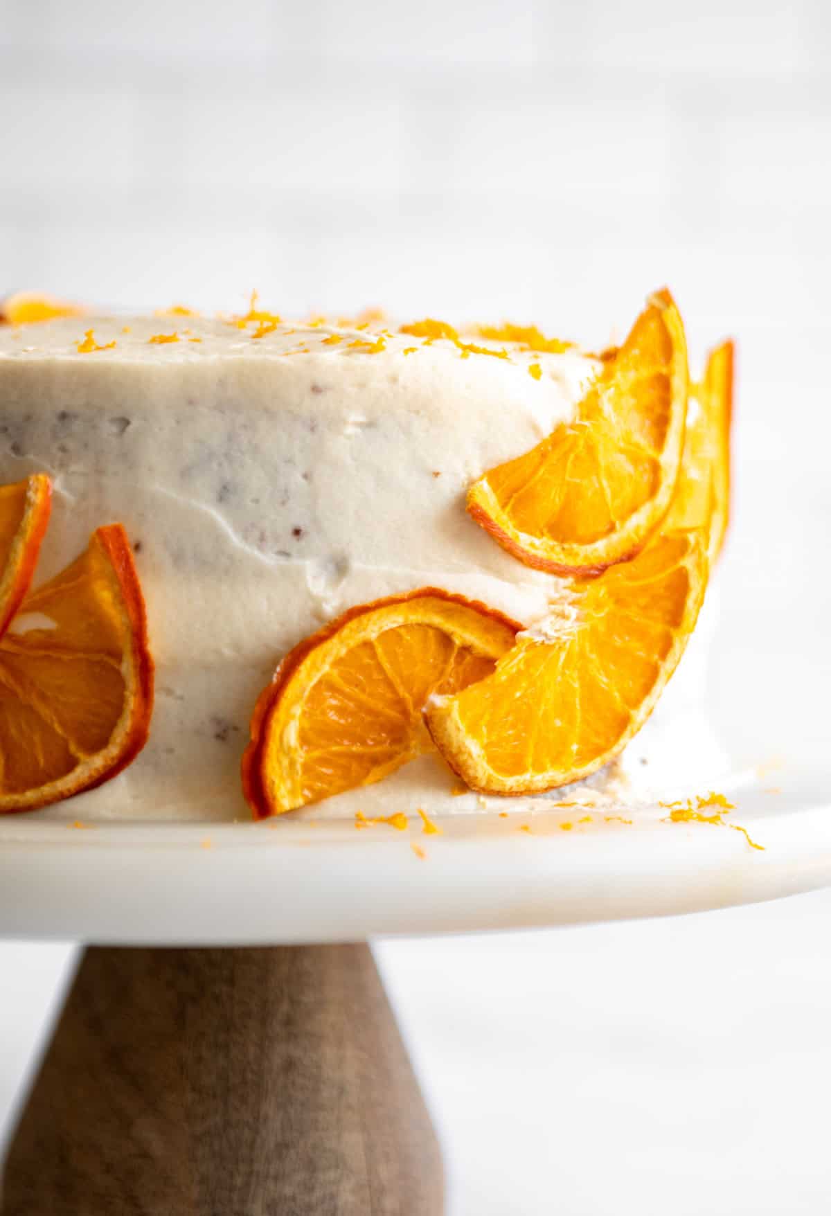 frosted orange cake with orange slices on the side