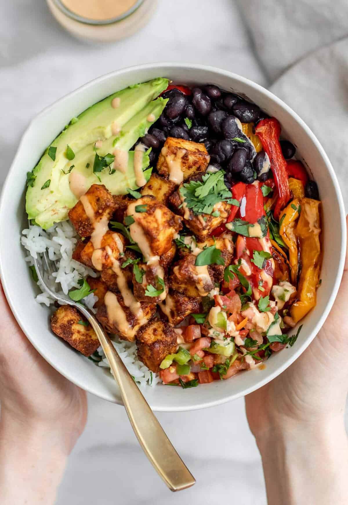 vegan burrito bowl with baked tofu and veggies