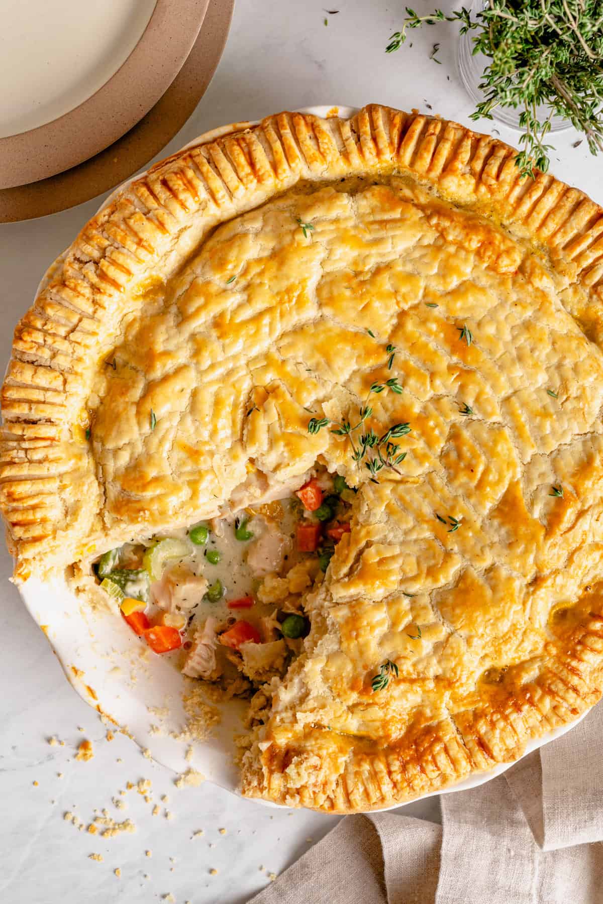 gluten free chicken pot pie in a pie dish with a slice taken out