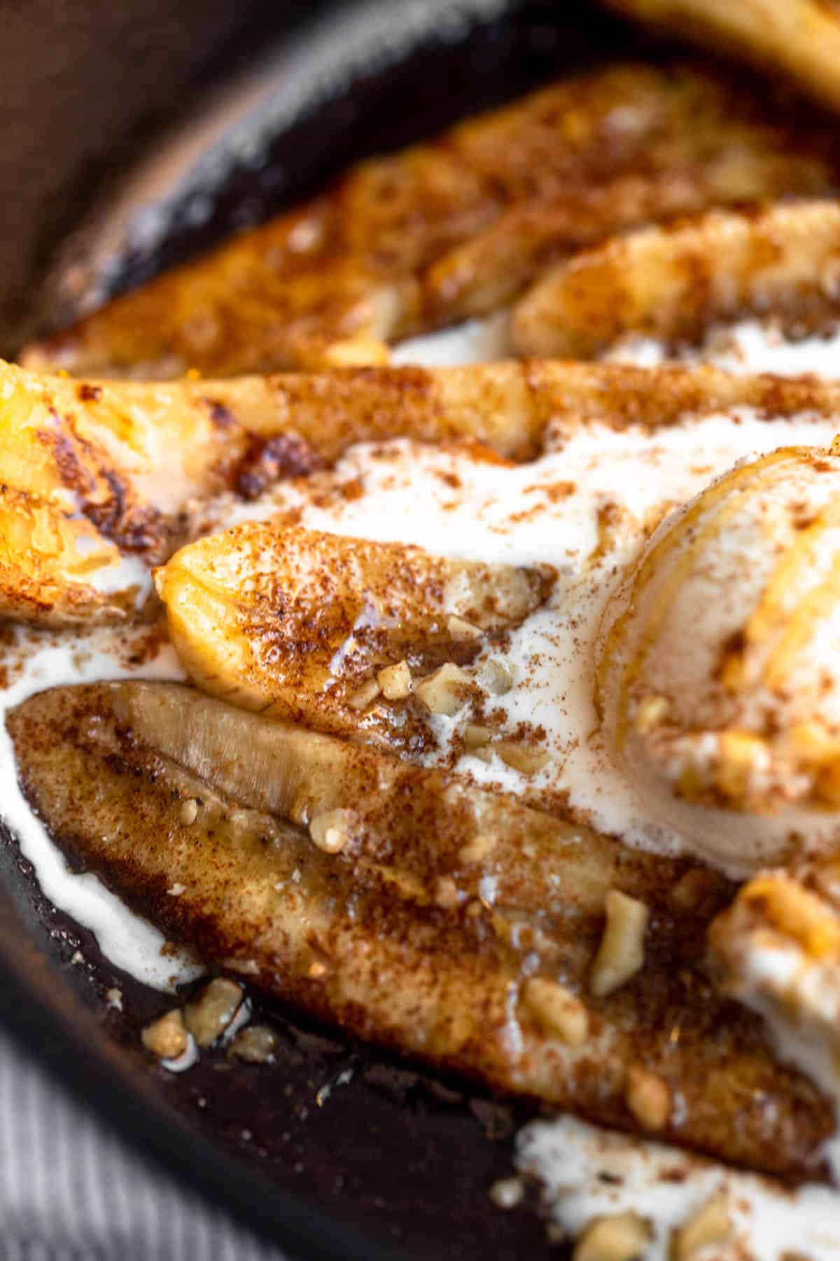 baked bananas with ice cream and crushed nuts