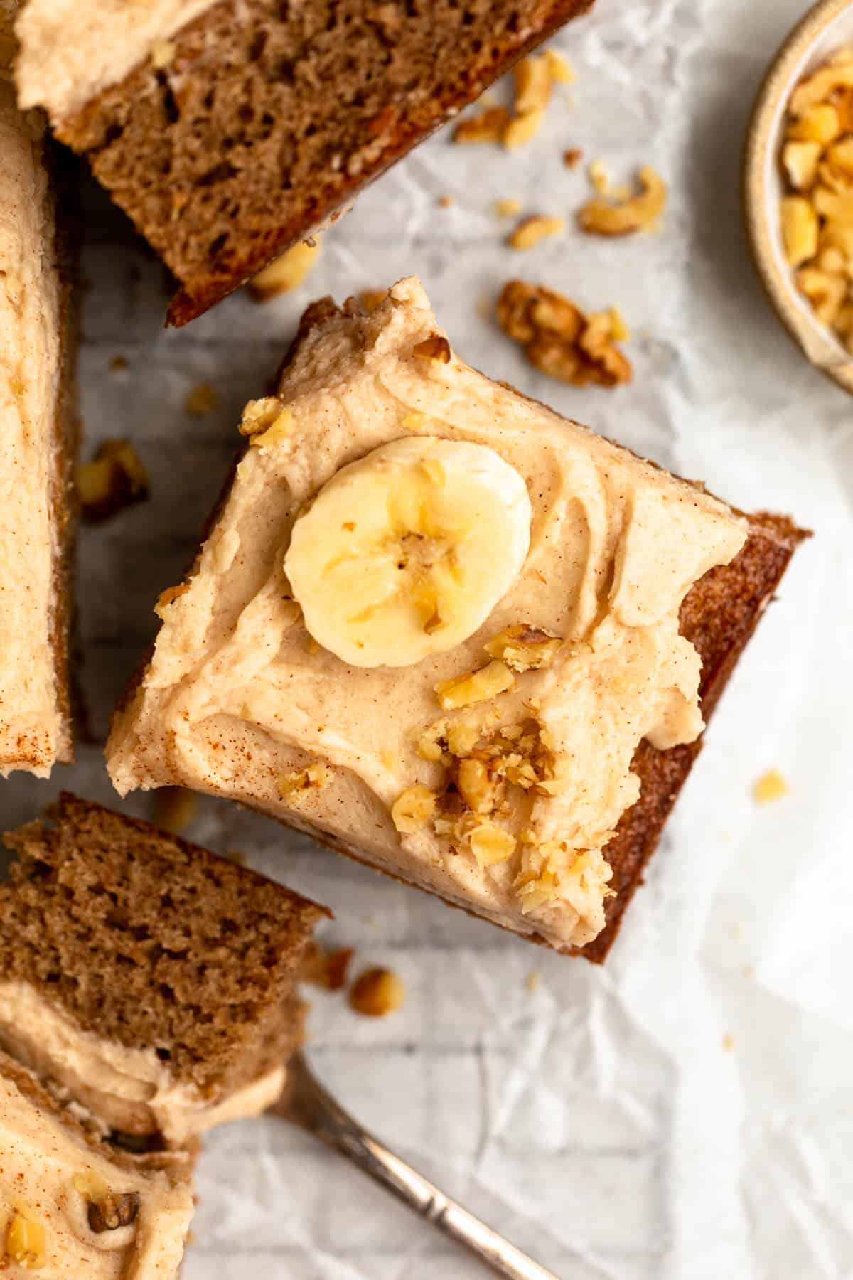 slice of the banana bread bars on a wire rack with walnuts