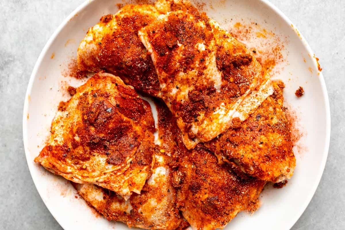 meat in a bowl with seasoning