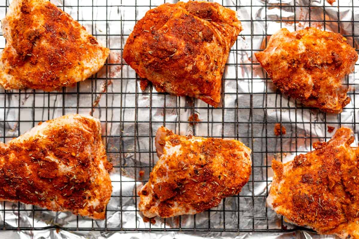 chicken thighs on a wire rack before baking