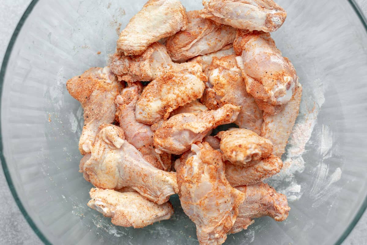 chicken wings in a bowl with spices