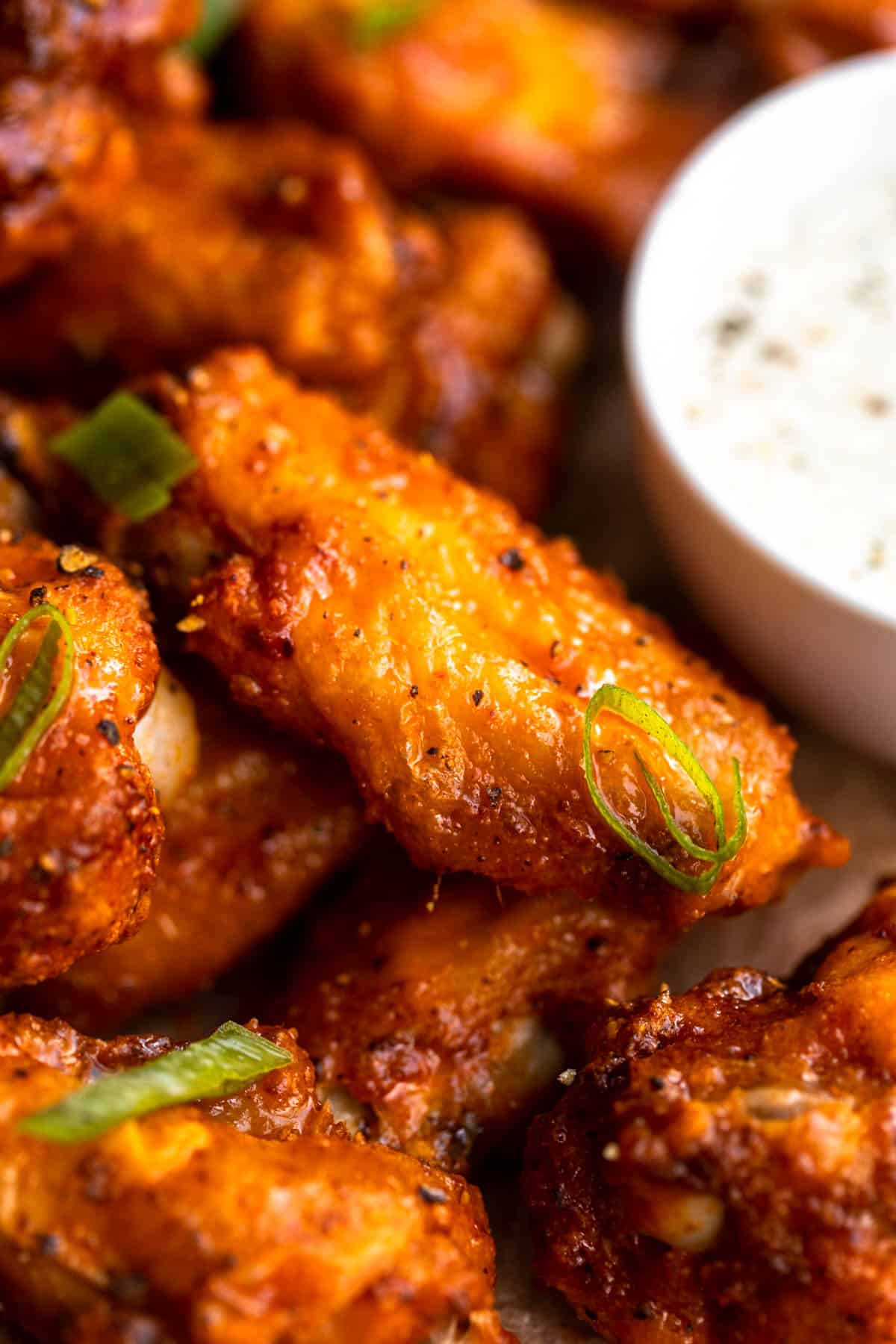 up close of the gluten free chicken wings with buffalo sauce to show crispy texture