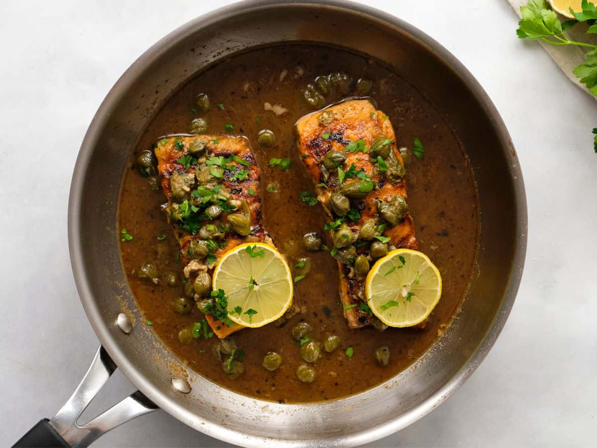 sauce in a pan with capers and fish 