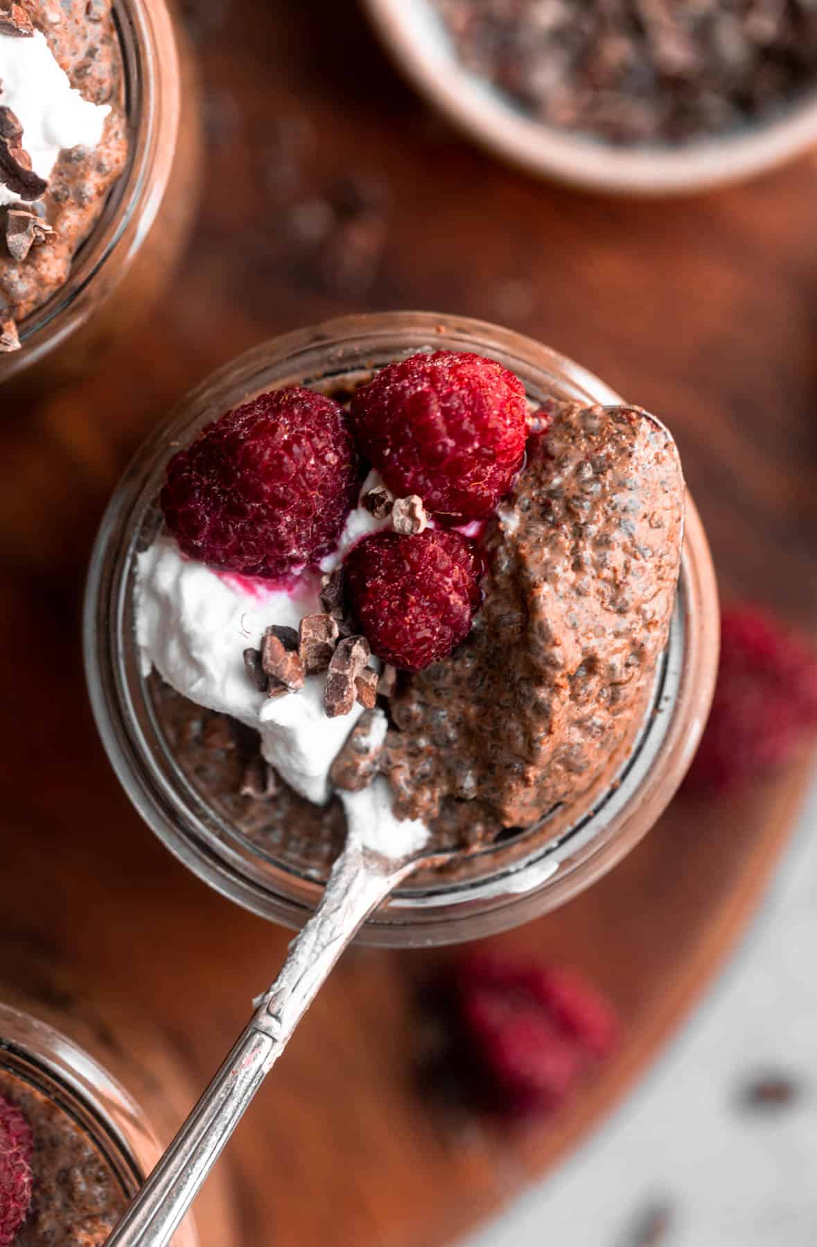 overhead shot of the chocolate chia pudding with a spoon to show texture