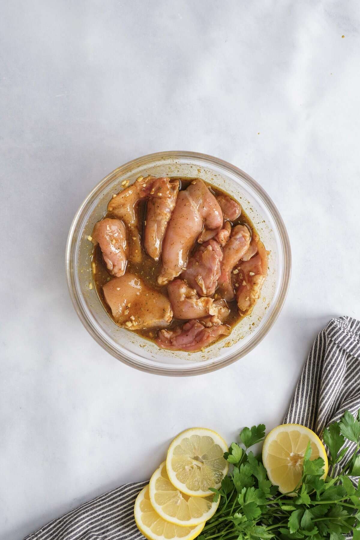 chicken thighs in a bowl marinating