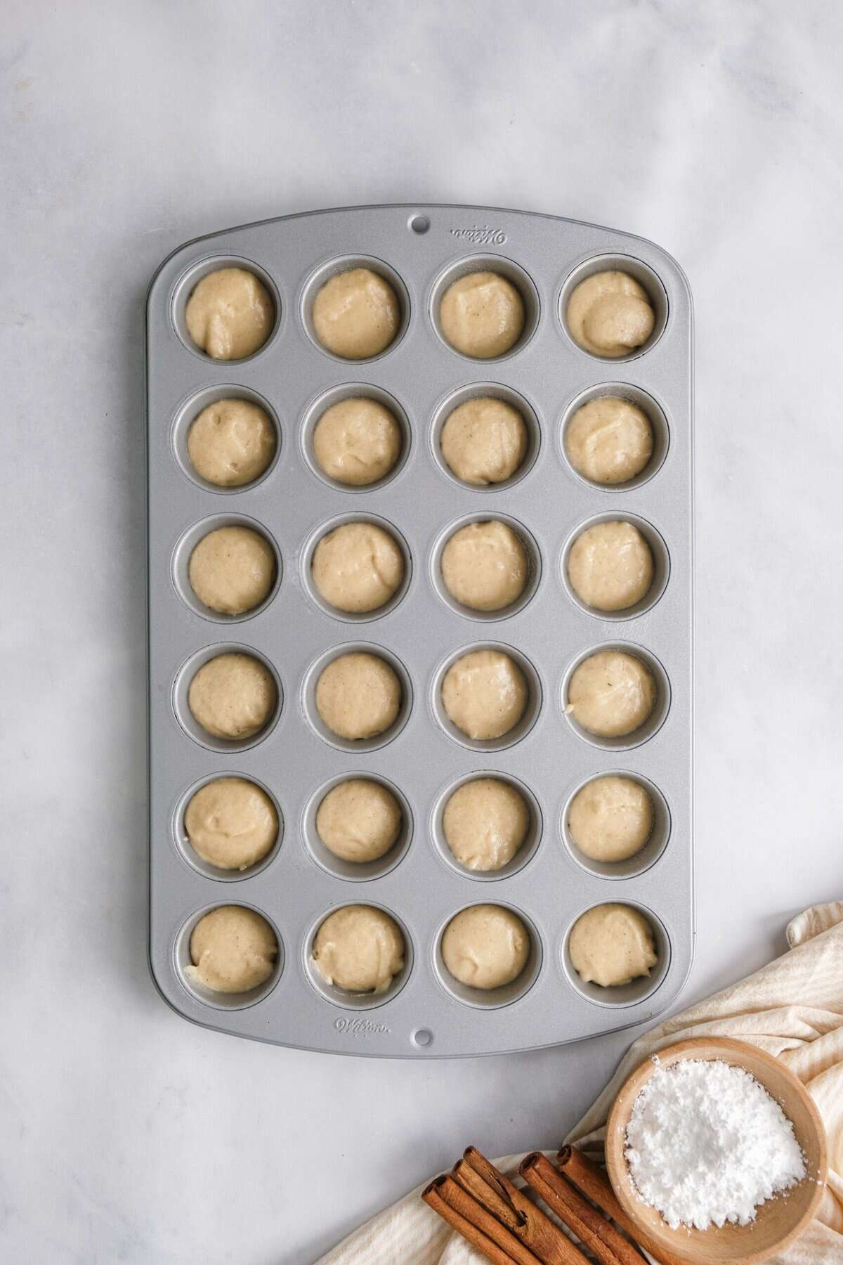 donut hole batter in a pan before baking