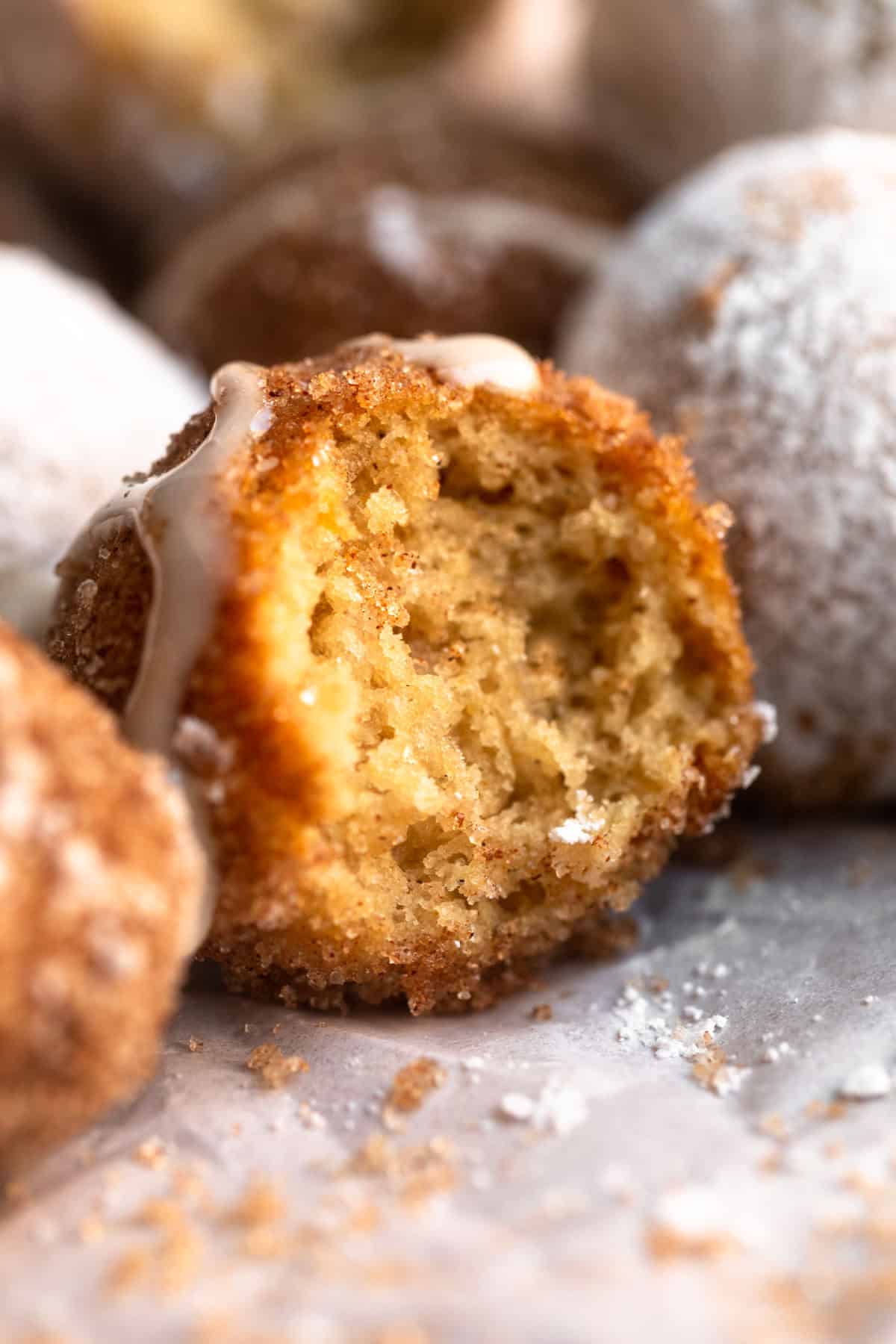 gluten free donut holes with a bite taken out to show texture