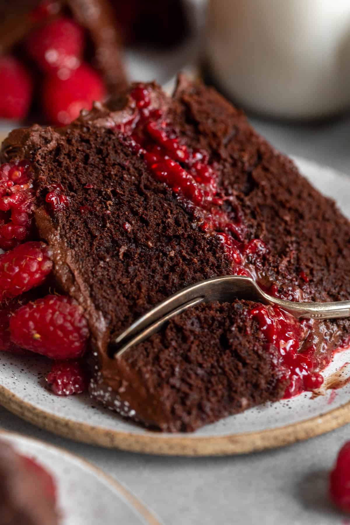 fork taking a bite of the gluten free chocolate cake with raspberry jam