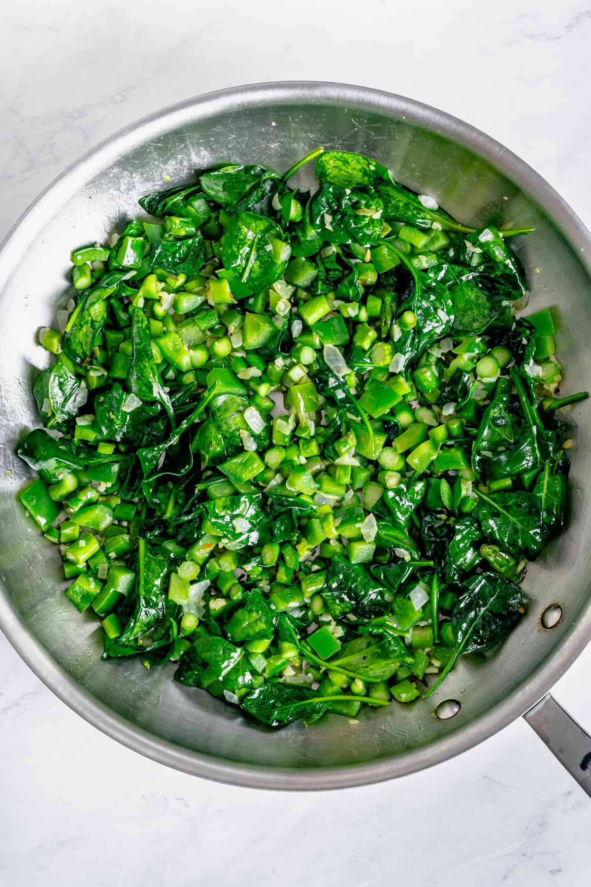 veggies sauteeing in a skillet