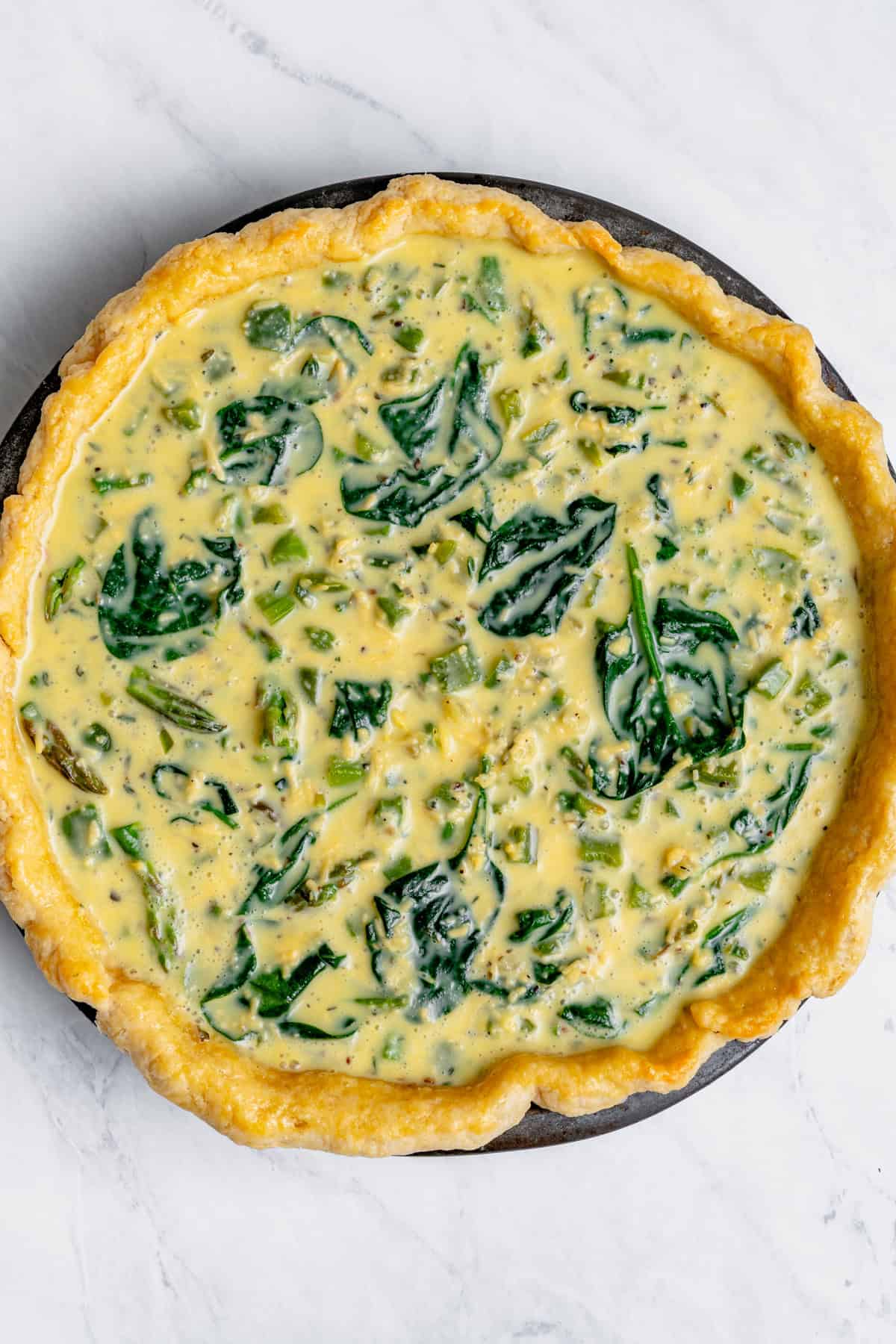 quiche in the dish before baking