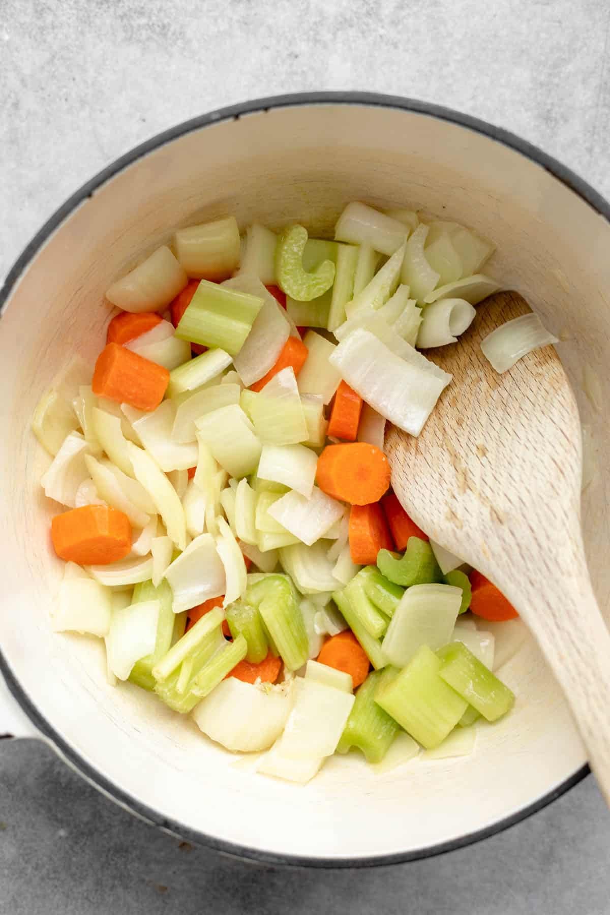 sauteeing the veggies in a pot with broth