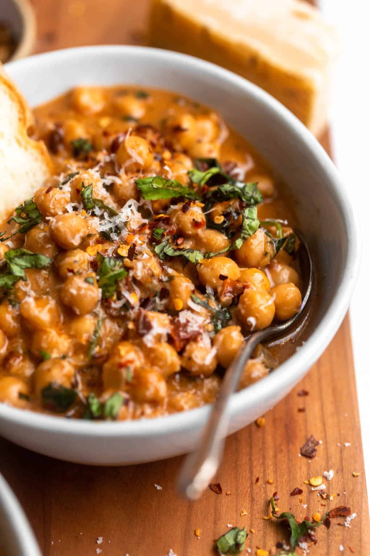 marry me chickpeas in a bowl with a spoon on the side