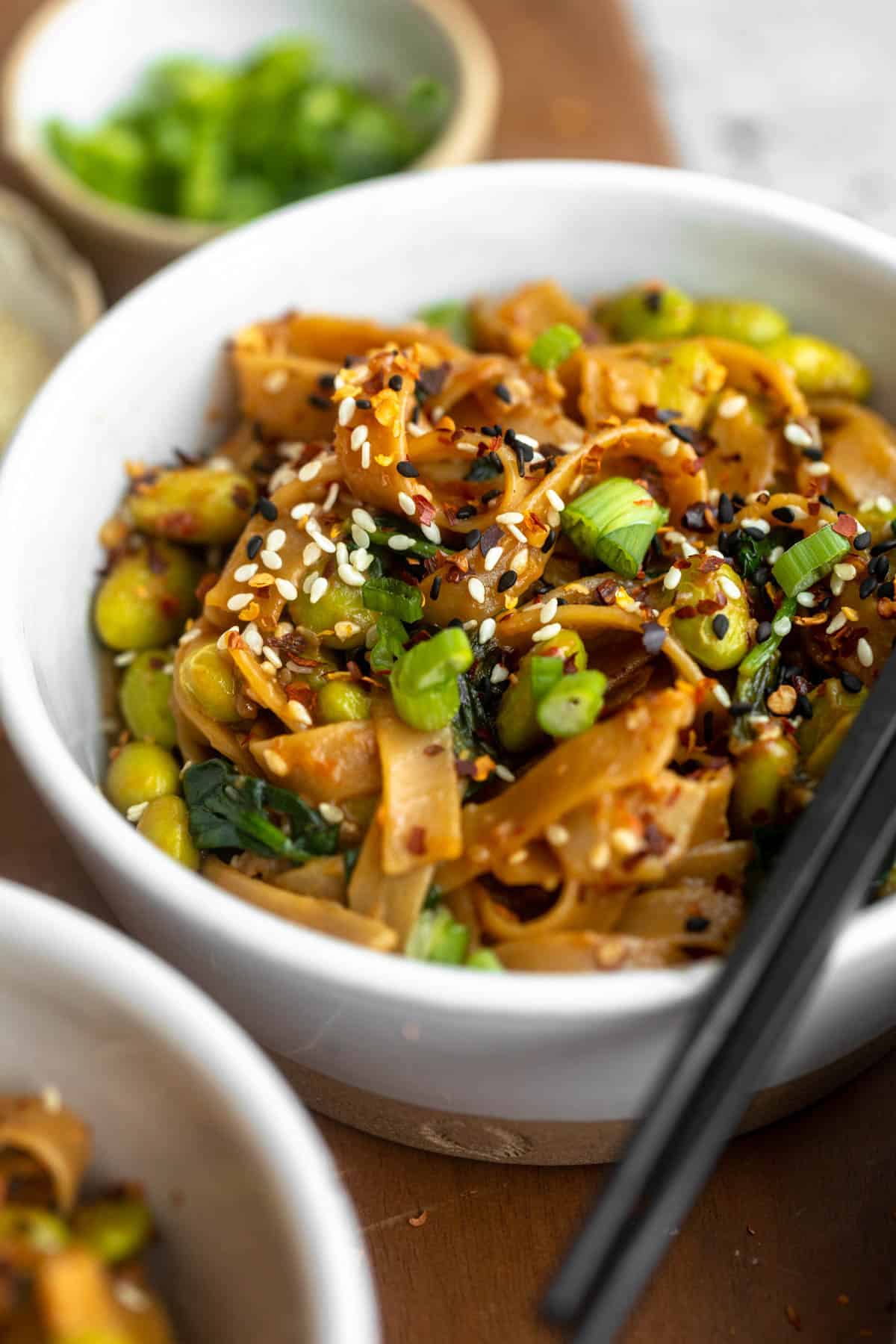 up closed angled view of the miso noodles with edamame