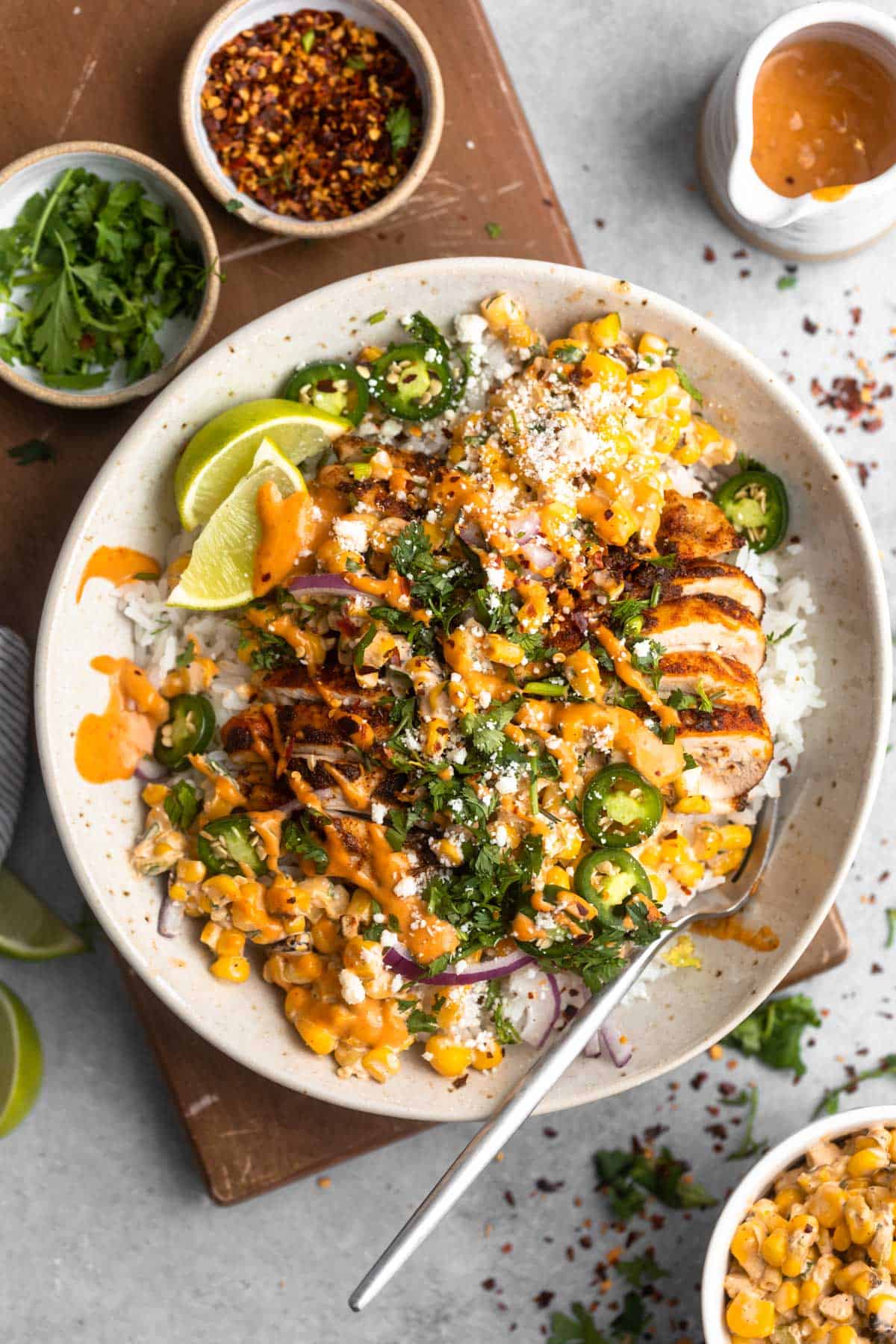 street corn chicken and rice bowls with a fork on the side
